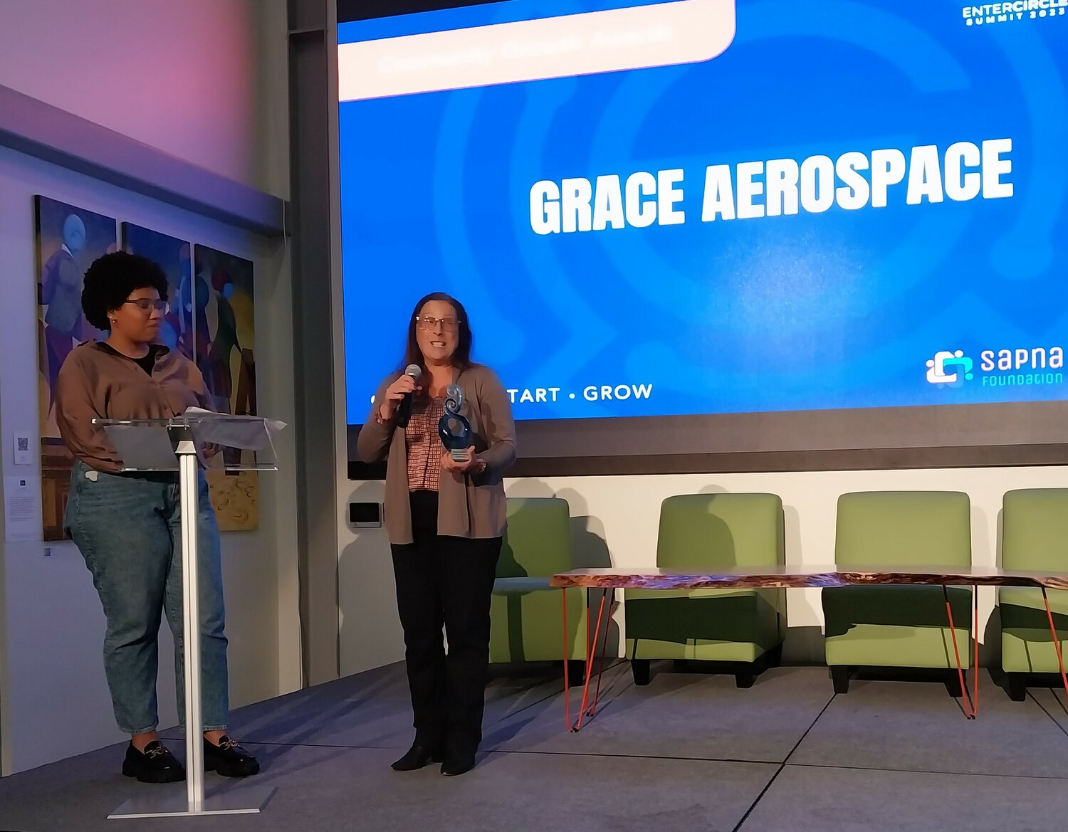 Pauline Sevigny, right, of Grace Aerospace receives a Community Growth Award.